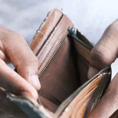 financial problems man opening wallet