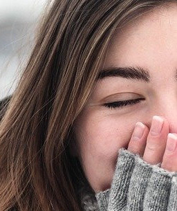 a woman covering her mouth with her hand
